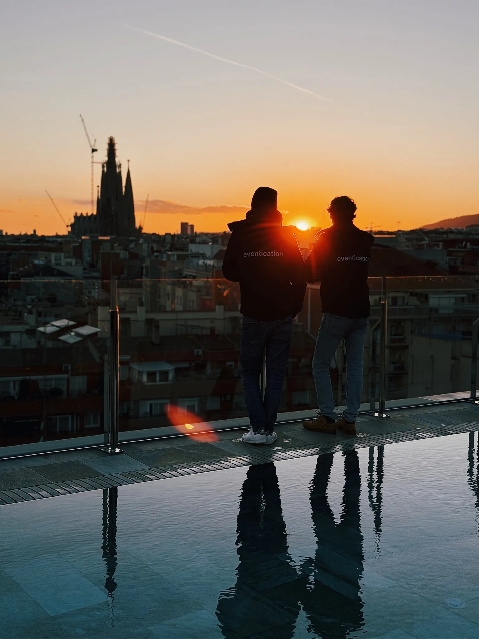 Two Eventication teammates looking over Barcelona at sunset.