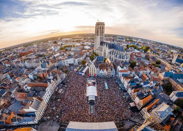 Aerial view of the Maanrock festival crowd filling a city square in Mechelen.